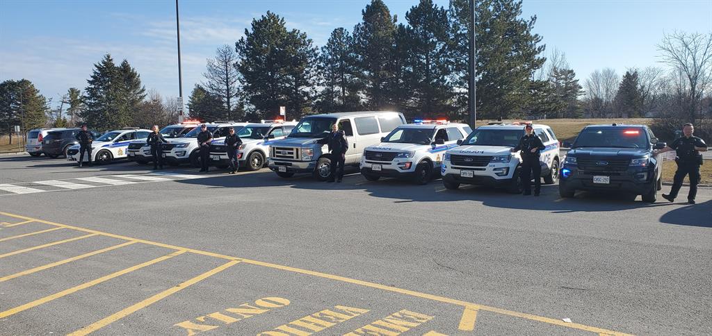 police lined up by cars
